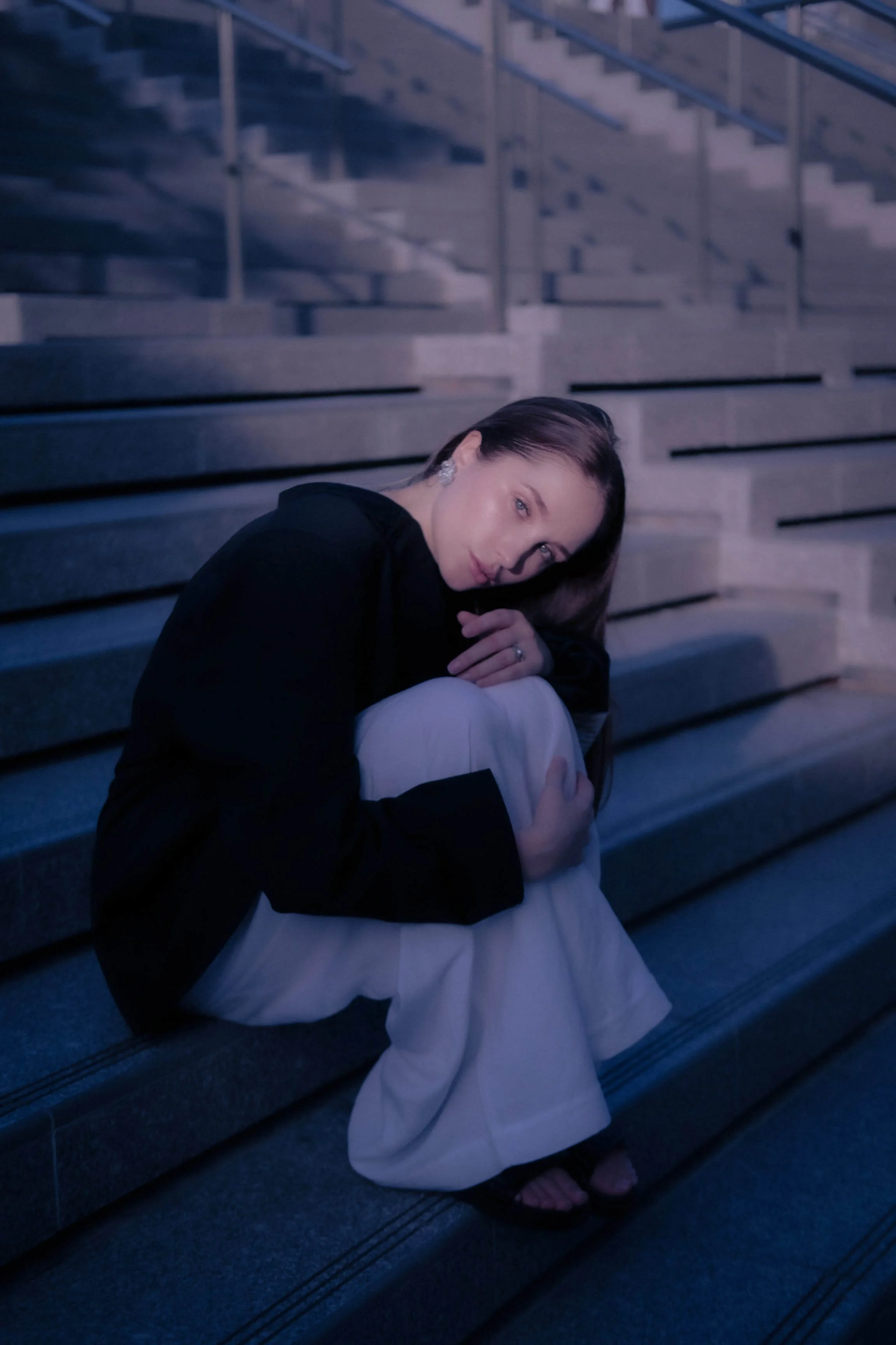 Girl sitting on stairs outside