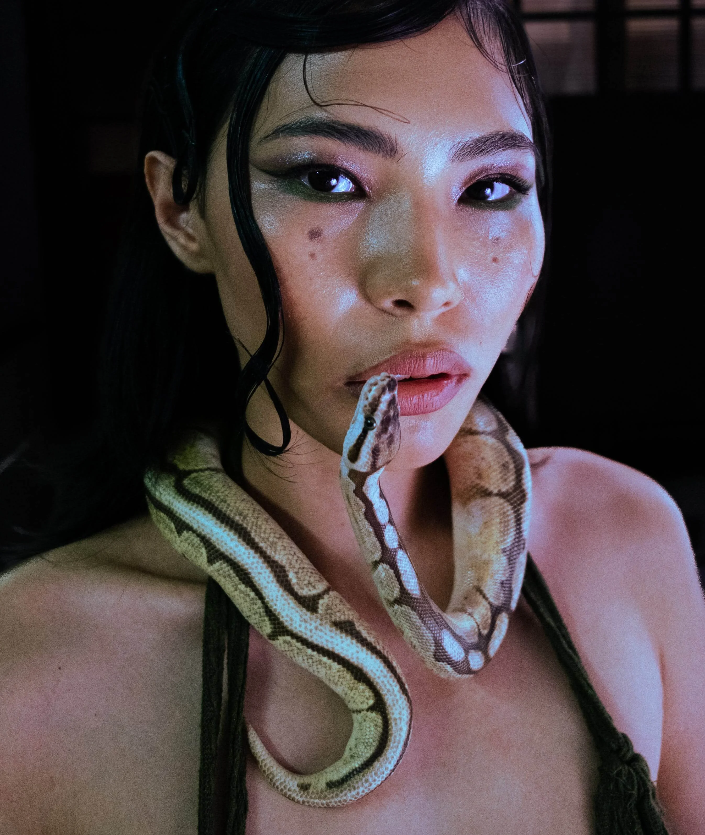 Portrait of a girl with a snake around her neck